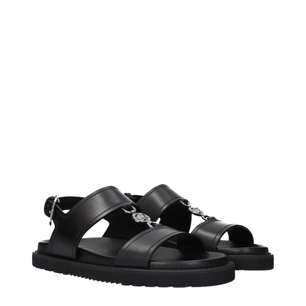 Versace Flache Sandalen aus schwarzem Leder