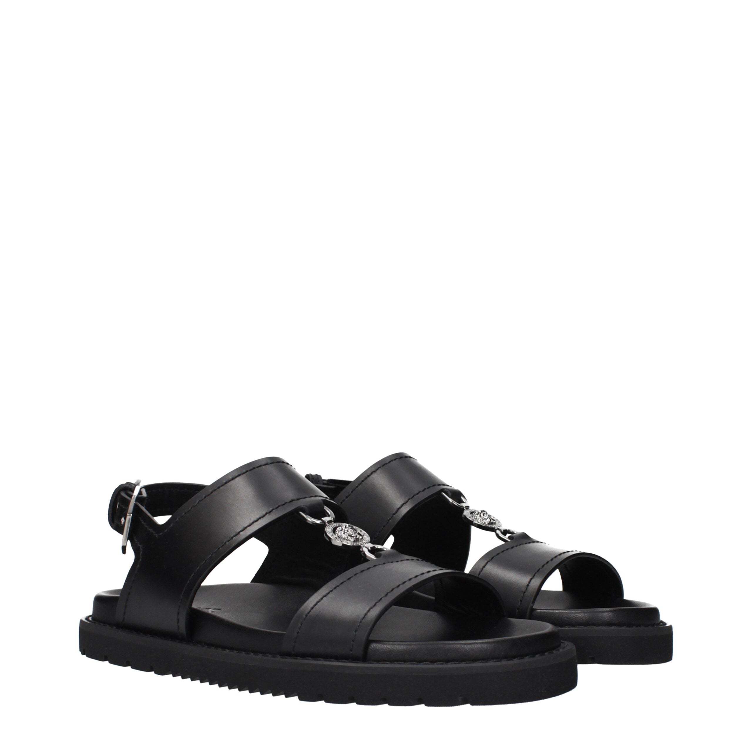 Versace Flache Sandalen aus schwarzem Leder