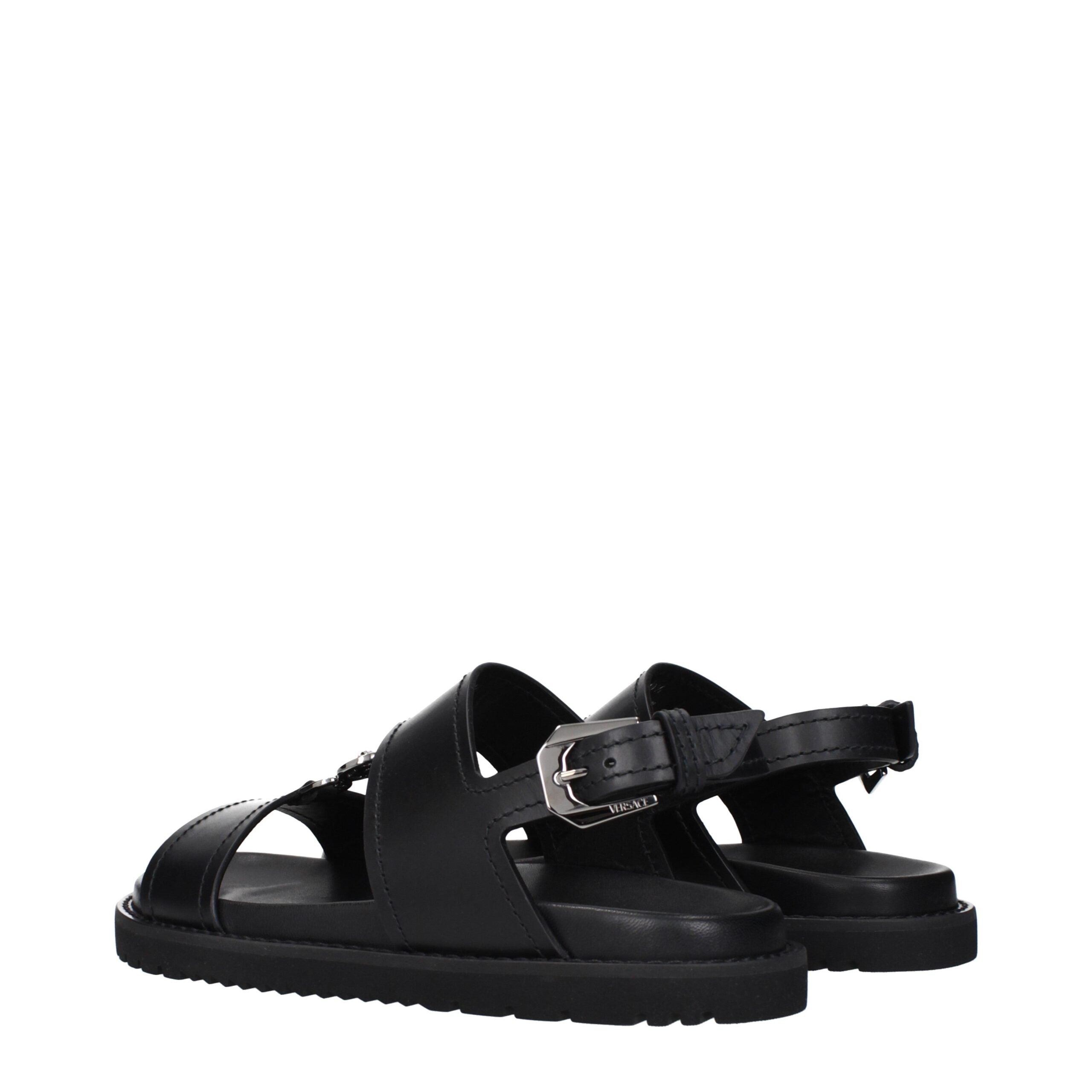 Versace Flache Sandalen aus schwarzem Leder